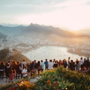 group of people standing facing lake view