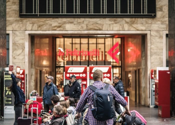 person standing beside the luggage bags